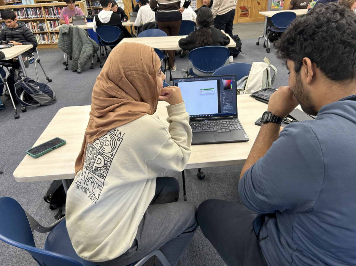 Senior editors Areej Zaidi and Alvin Paul caught mischievously editing on Photoshop.

